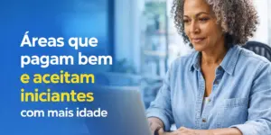 Mulher com cabelo grisalho trabalhando em laptop em escritório iluminado